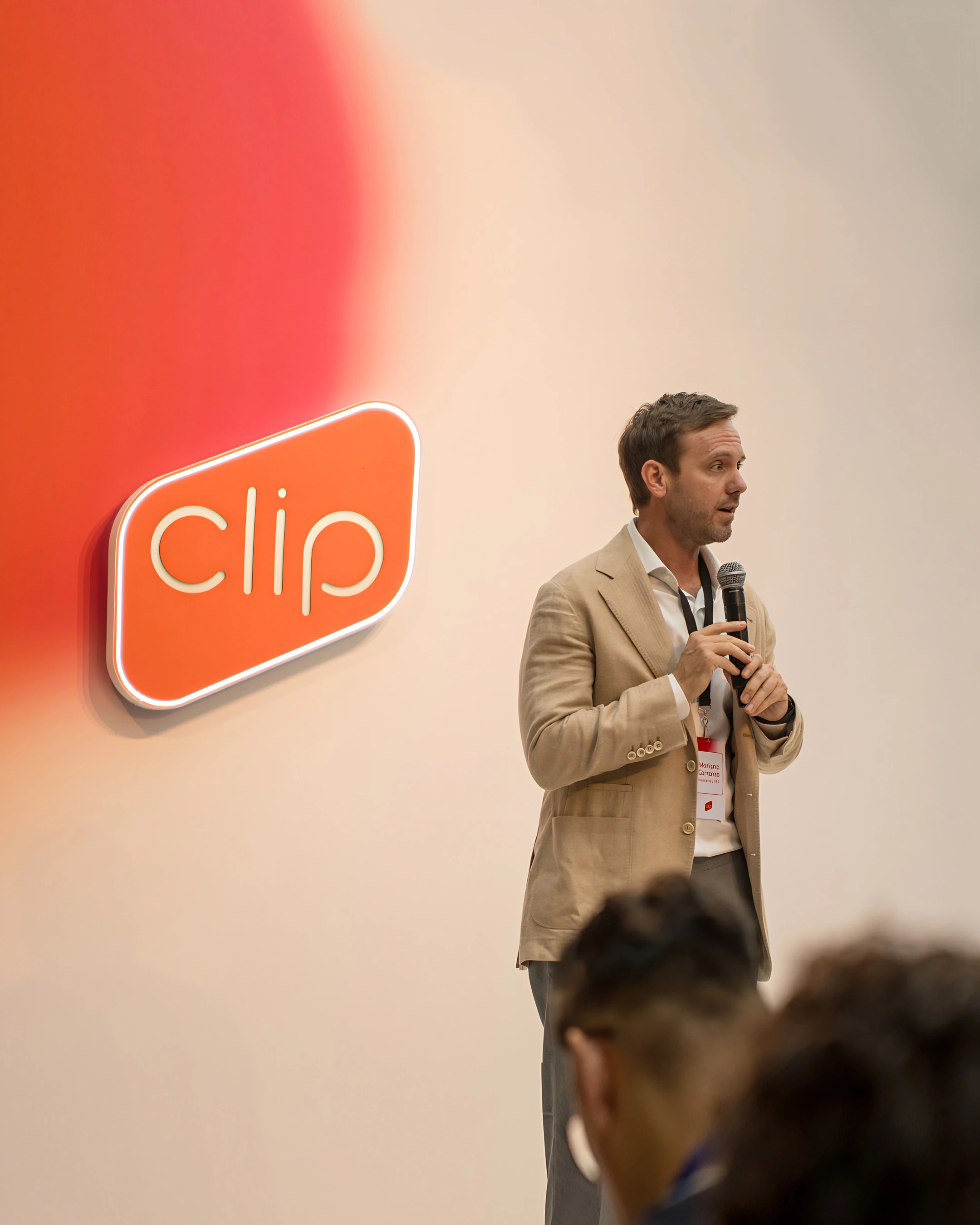 Speaker on stage next to the Clip logo at the Mi Clip launch
