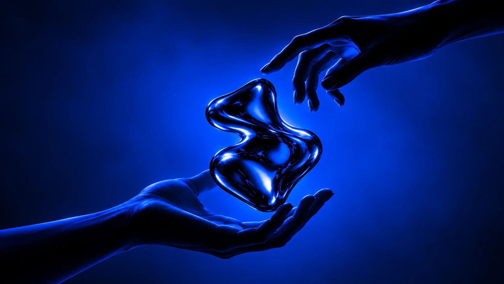 Two hands around a liquid chrome sculpture