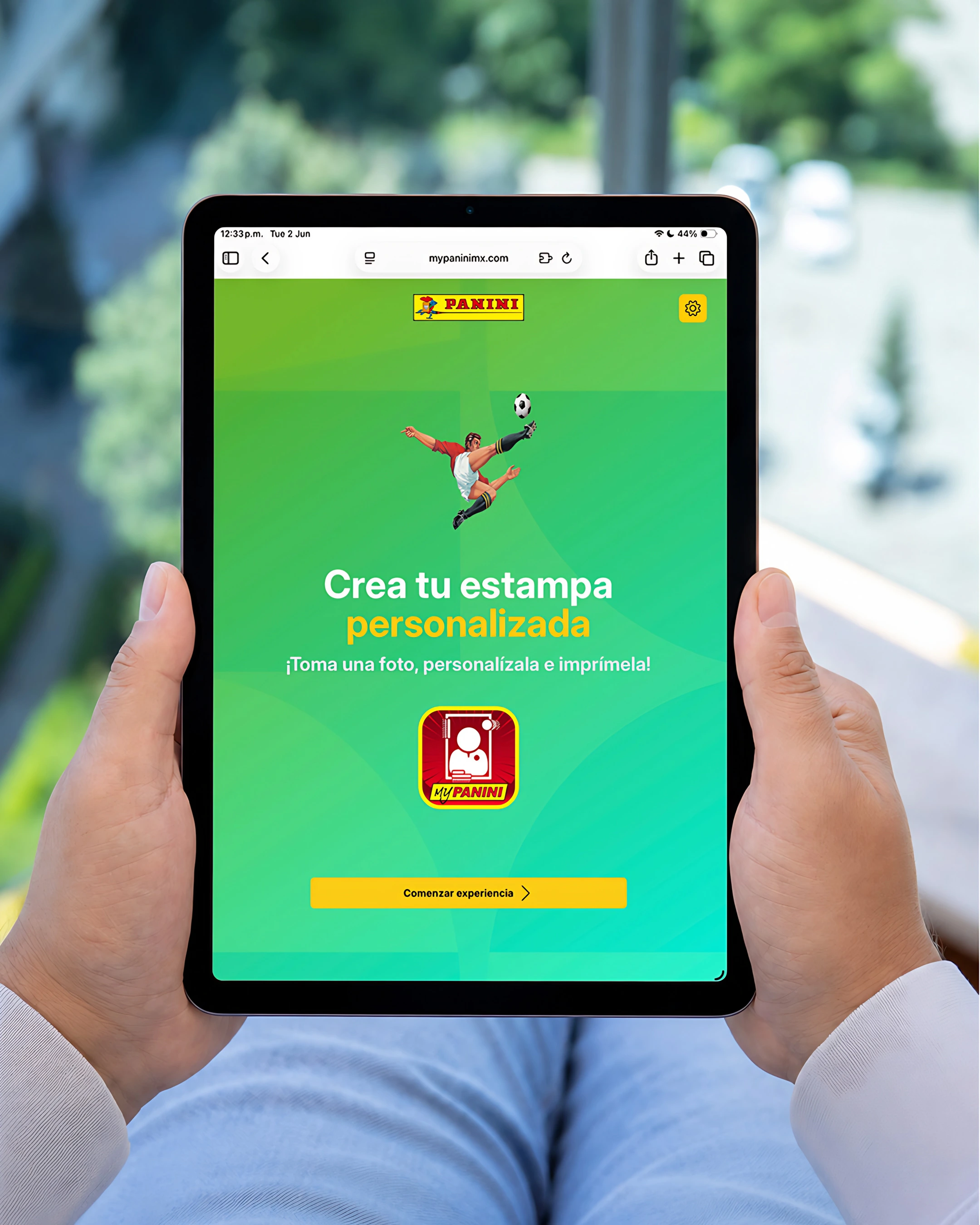 Hands holding a tablet with the My Panini site: “Create your personalized sticker”